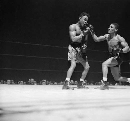 Lightweight Boxer Punching Opponent in Bout