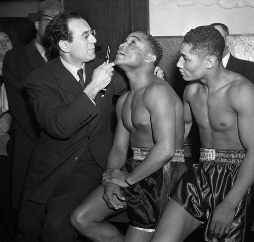 Doctor Checks Henry Armstrong's Eye