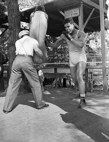 Henry Armstrong Holding Bag for Joe Louis