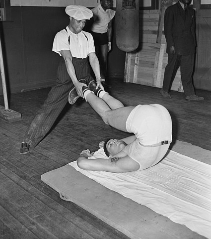 Man Holding Joe Louis' Legs